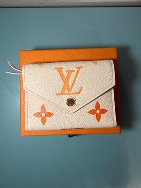 LOUIS VUITTON Monogram Empreinte Tri-Fold Wallet Orange Cream